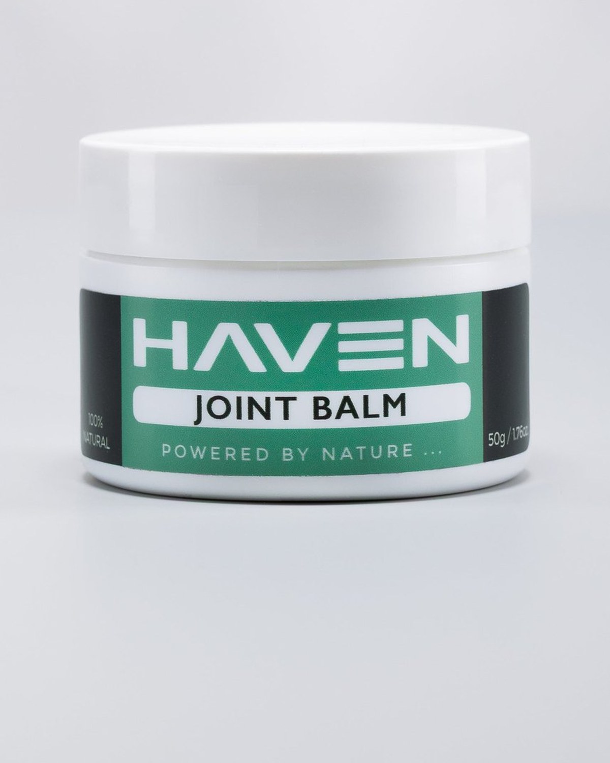 Haven Joint Balm, a white jar with a green label, photographed on a pale seamless background